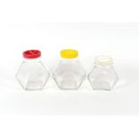 Three Italian Art Deco style glass storage jars, with plastic screw tops
