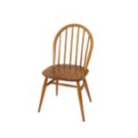 A set of four light Ercol stick back kitchen chairs