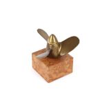 A bronze propeller on marble plinth