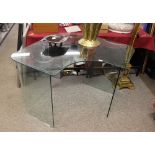 A modern shaped glass writing desk, 130cm wide in extremes