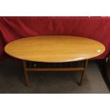 An oval simulated walnut retro coffee table, with
