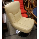 A cream leather and chrome based swivel easy chair