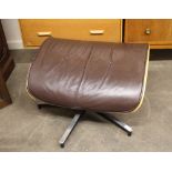 An Eames style bentwood and leather upholstered footstool on metal base