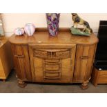 A 1930's oak bow fronted sideboard, having raised