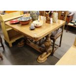 A 1930's light oak draw leaf extending dining table, raised on baluster end supports, 104cm wide