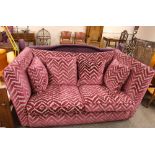 A large Sofology square back three seat settee, upholstered in raised pink dralon