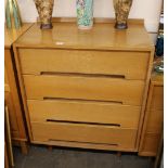 A 1960's light wood chest of four long drawers, ra