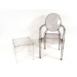 A Louis Starck Cartell ghost armchair and coffee table