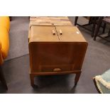 A walnut sewing table, of curved form, raised on rubber castors