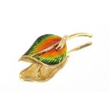 A yellow metal and enamel leaf shaped brooch, set