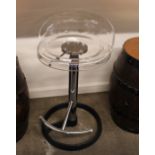 A plastic and chrome revolving high stool