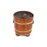 An Art Deco design oak and copper banded coal bucket, flanked by stylised carrying handles, 37cm
