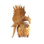 A carved wooden figure of an eagle, 39cm high
