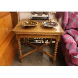 A 1930's oak draw leaf dining table raised on barl