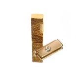 A 9ct gold cigar cutter, with engine turned decora