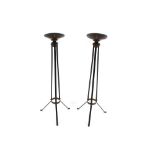 A pair of wrought metal and brass candle stands, 90cm high
