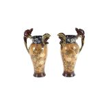 A pair of Doulton Lambeth ewers, decorated with fis