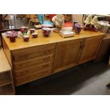 A Harlequin of Salisbury Rhodesia walnut sideboard, the interior shelves enclosed by a pair of