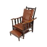 A 1930's oak reclining chair, with integral foot rest, label Norton Bros. Ltd., London