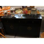 An Oriental design black and gilt decorated sideboard, fitted three drawers with cupboards under,