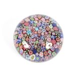A Millefiori glass paperweight, 7cm dia, 5cm high, 507g total weight. Numerous bruises and blemishes