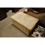 A stripped upholstered foot stool