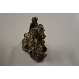 An oriental brass figure in the form of a monkey o