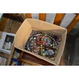 A box of various bead necklaces and costume jewelle