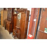 An oak veneered mirrored hall stand and cupboard