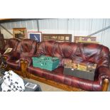 An oak and red leather three piece suite comprisin