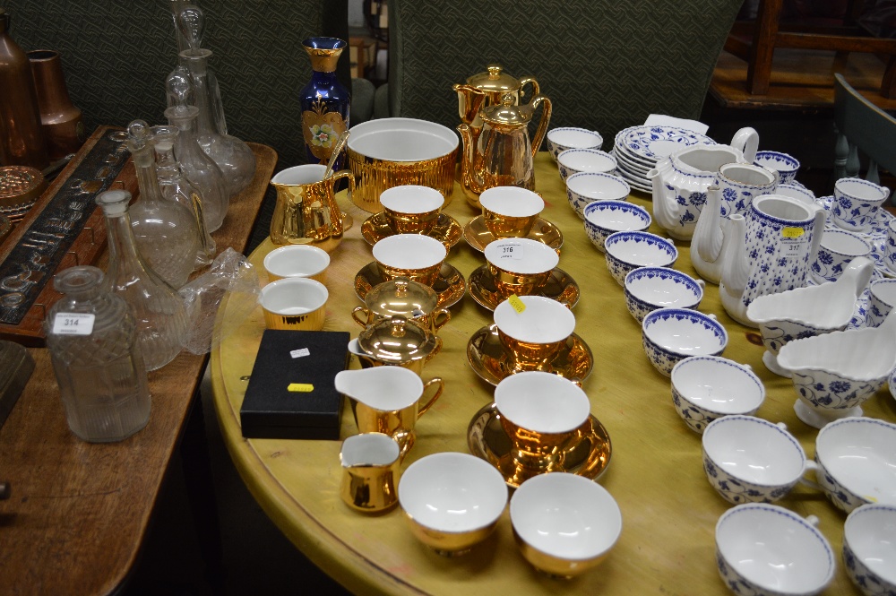 A quantity of gold painted teaware; an over laid g