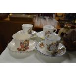 Four commemorative tea cups and saucers