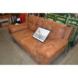 A brown leather two seater sofa