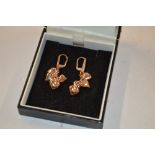 A pair of heart shaped drop ear-rings