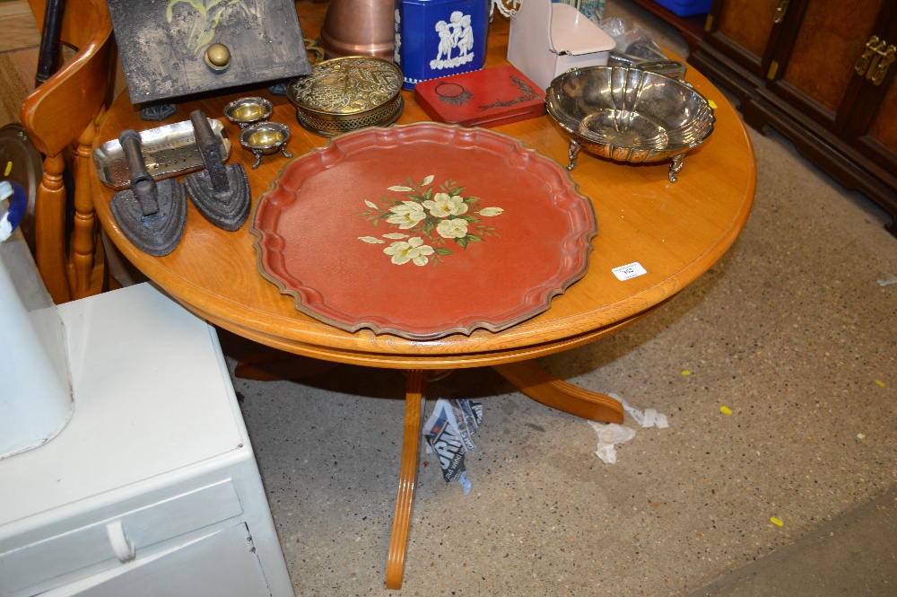 An oak circular topped kitchen table with a set of