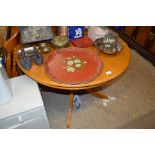 An oak circular topped kitchen table with a set of