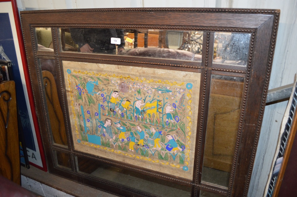 An oak framed and decorated mirror