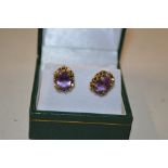A pair of yellow metal and amethyst set ear-rings