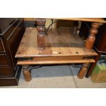 A large hardwood square top coffee table