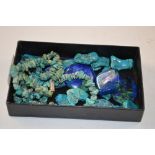 A tray containing a turquoise stone necklace; and