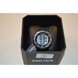 A Police black digital wrist watch in original box