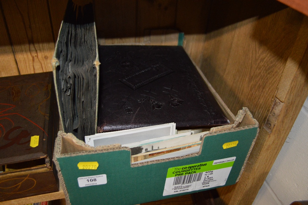 A box containing a photo album, post-card album an