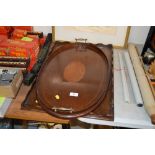 An Edwardian mahogany and inlaid oval tray; and on