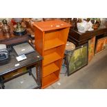 A narrow pine bookcase