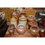 A quantity of various stoneware storage jug; flago