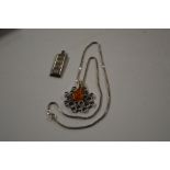 A silver and amber pendant hung to a fine link cha