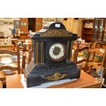 A late Victorian black slate two hole mantle clock