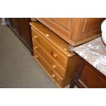 A modern pine chest fitted three drawers