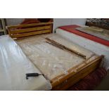 A pine framed double bed and mattress