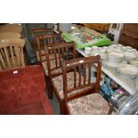 A set of four reproduction mahogany dining chairs